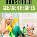 mom and toddler wearing cleaning gloves and laughing while spraying each other with all natural chemical free kid safe cleaner DIY homemade by The Moments At Home