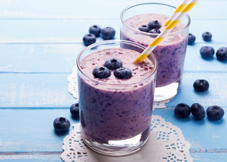 Two glasses of THM low carb blueberry smoothie with a straw