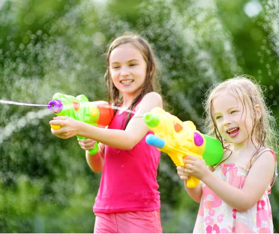 two girls have a water fight with family 