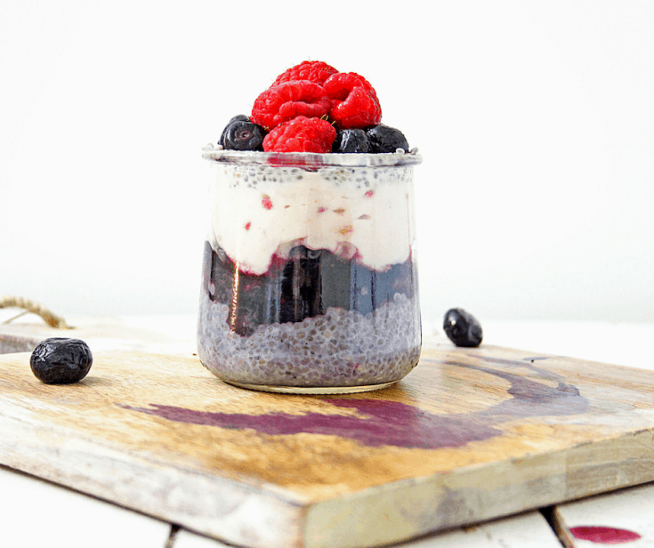 chia seed breakfast pudding jar topped with fresh berries