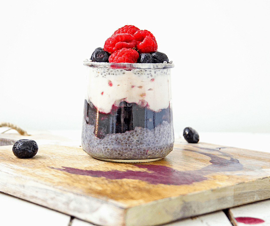 chia seed breakfast pudding jar topped with fresh berries