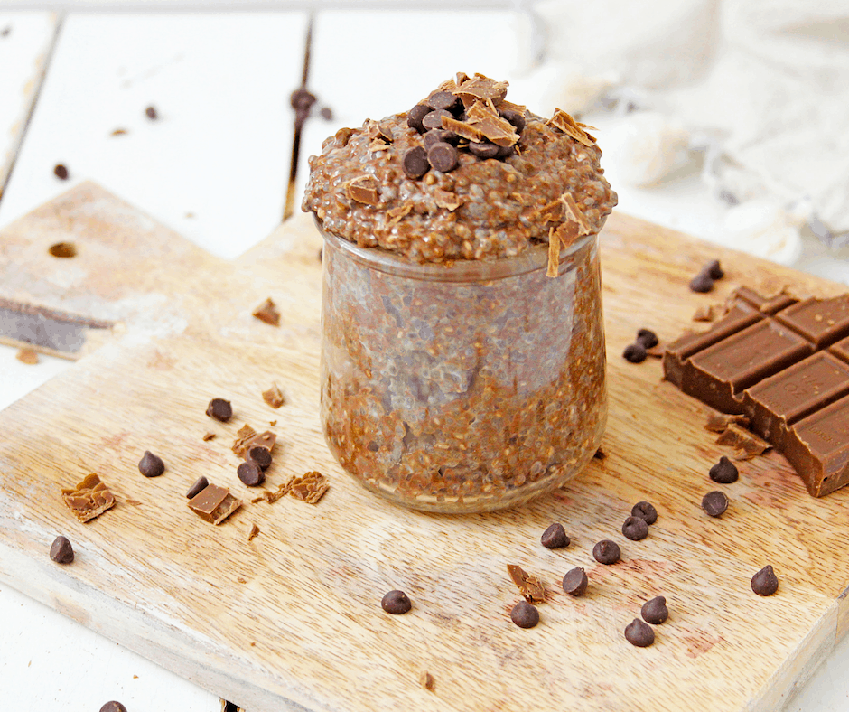 cup of chocolate chia pudding with coconut milk on a cutting board