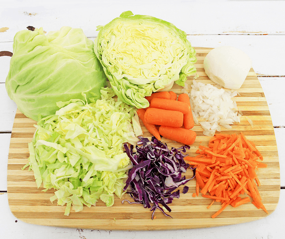 Picture of fresh cabbages, carrots, onion to make paleo pineapple coleslaw