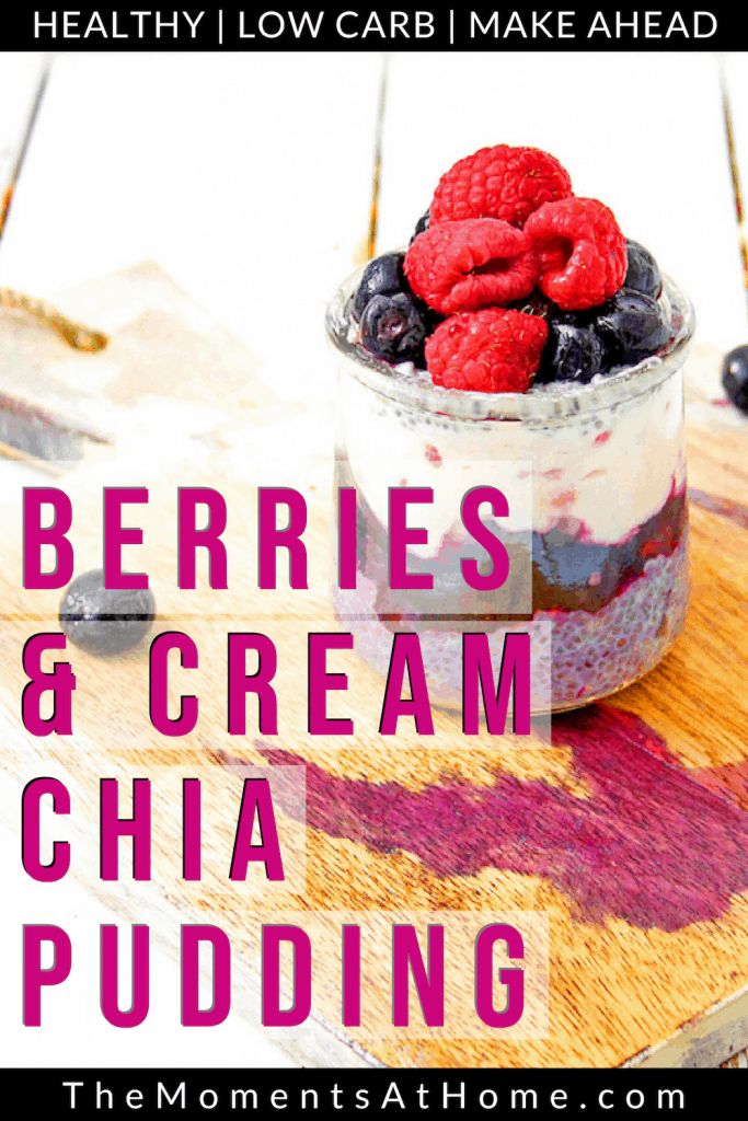 chia pudding with almond milk in a jar topped with berries on a wooden cutting board