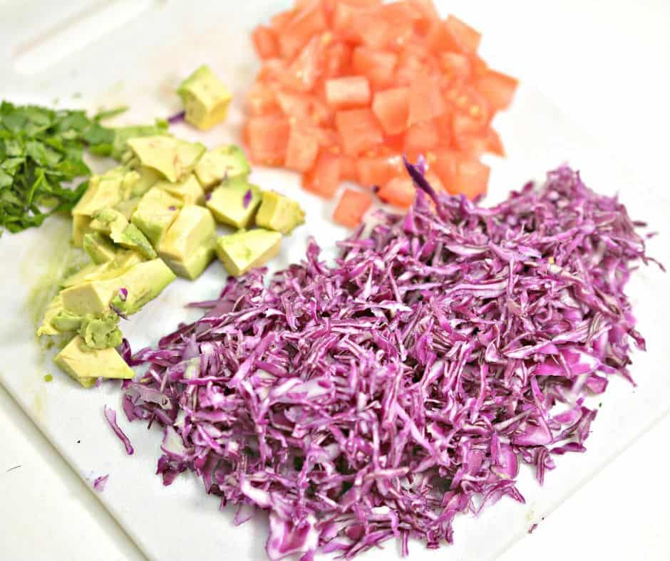 diced tomatoes, avocados, and purple cabbage for keto shrimp taco slaw