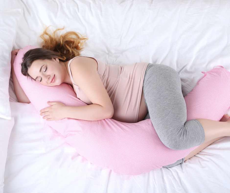 pregnant woman taking care of her health by resting and getting sleep using a pregnancy pillow