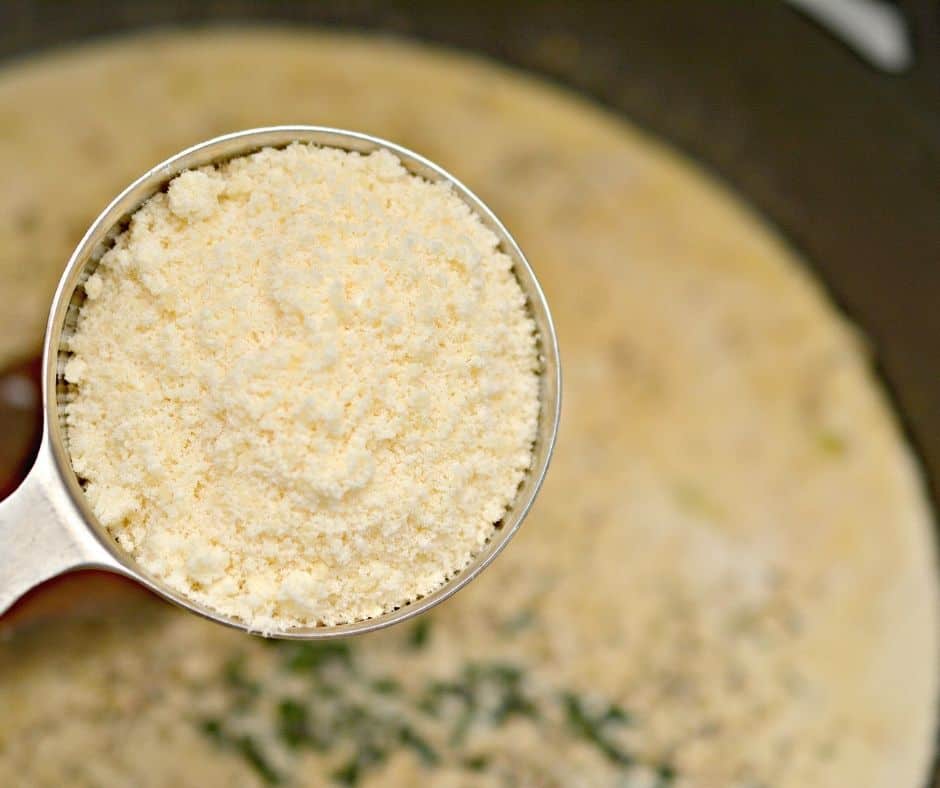 grated parmesan in a measuring cup to add to tuscan chicken skillet recipe