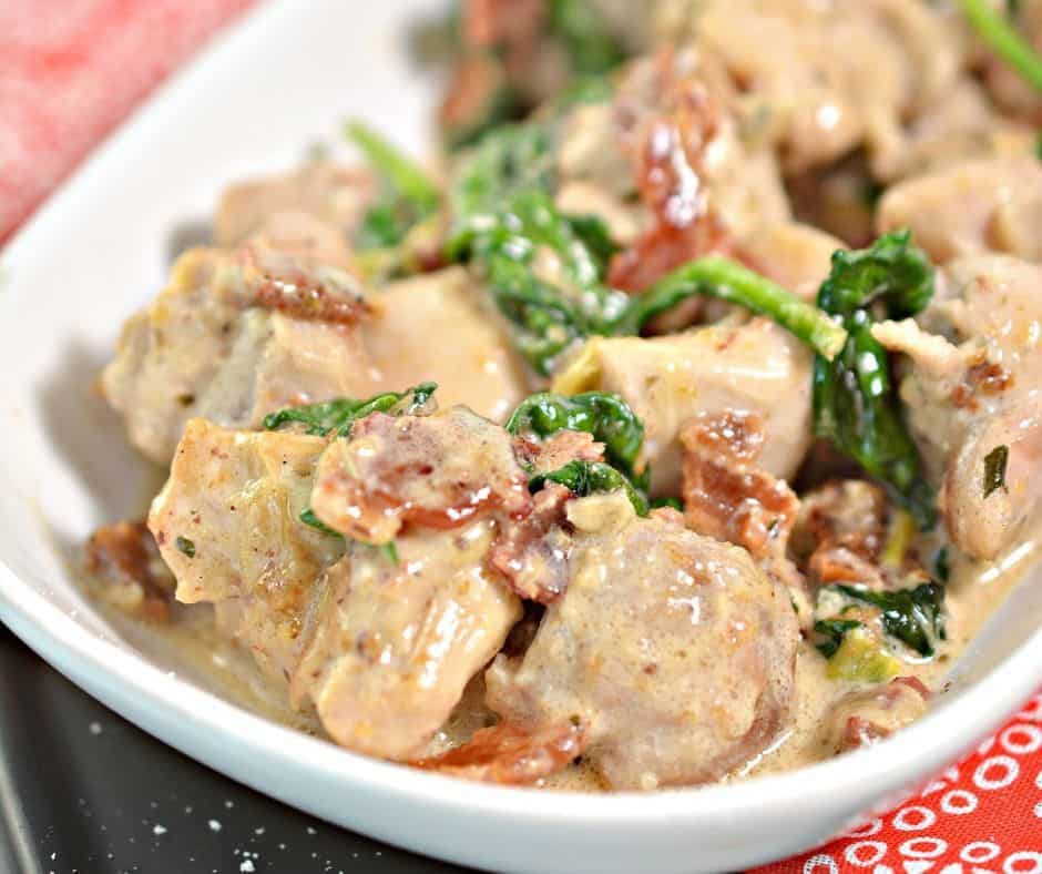 Serving dish on red tablecloth with tuscan chicken in it