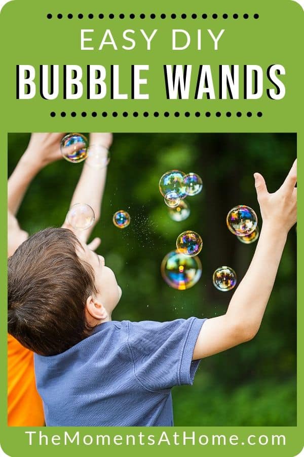 boys catching bubbles outside with words "easy DIY bubble wands" from The Moments At Home