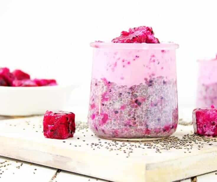 chia pudding made with almond milk and frozen dragonfruit cups on a wooden board