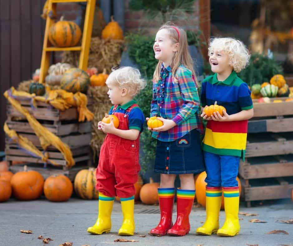 family tradition trip to pumpkin patch with three kids