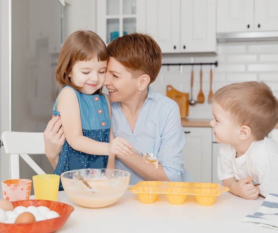 mom with son and daughter in kitchen to make cake