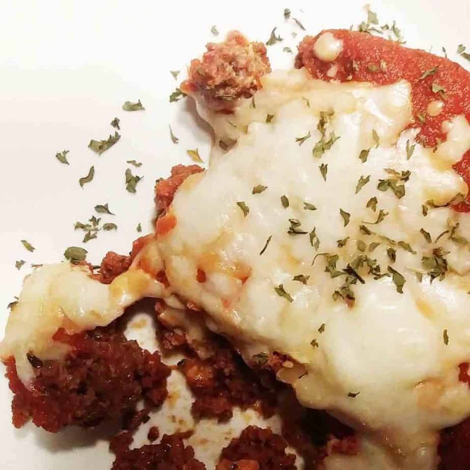 keto meatloaf without pork rinds smothered in tomato sauce and mozzarella with fresh chopped basil