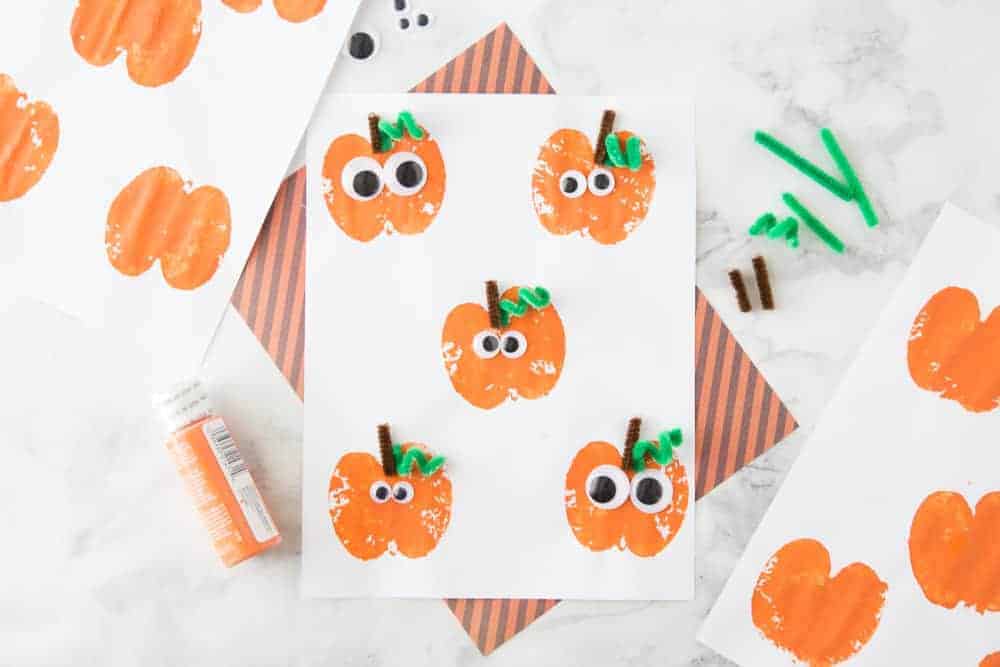 apple stamping autumn craft that looks like a pumpkin