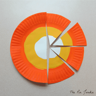 painted paper plate cut into wedges for a paper plate craft candy corn banner