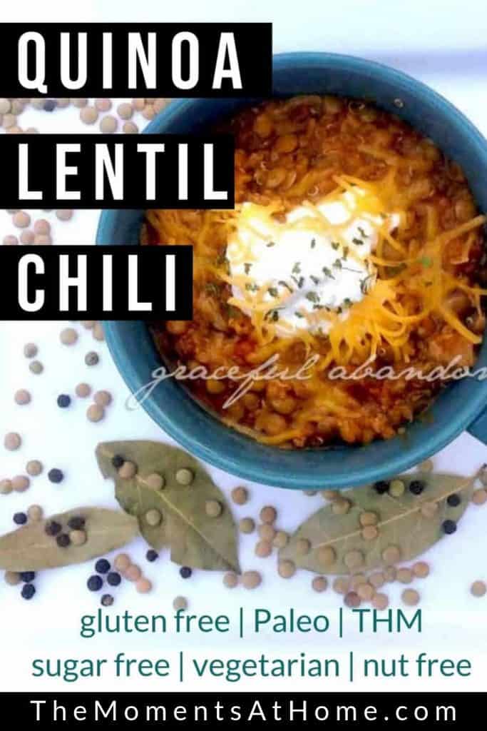 Chili topped with sour cream and cheese with lentils on plate for decor and text "quinoa lentil chili" by The Moments At Home