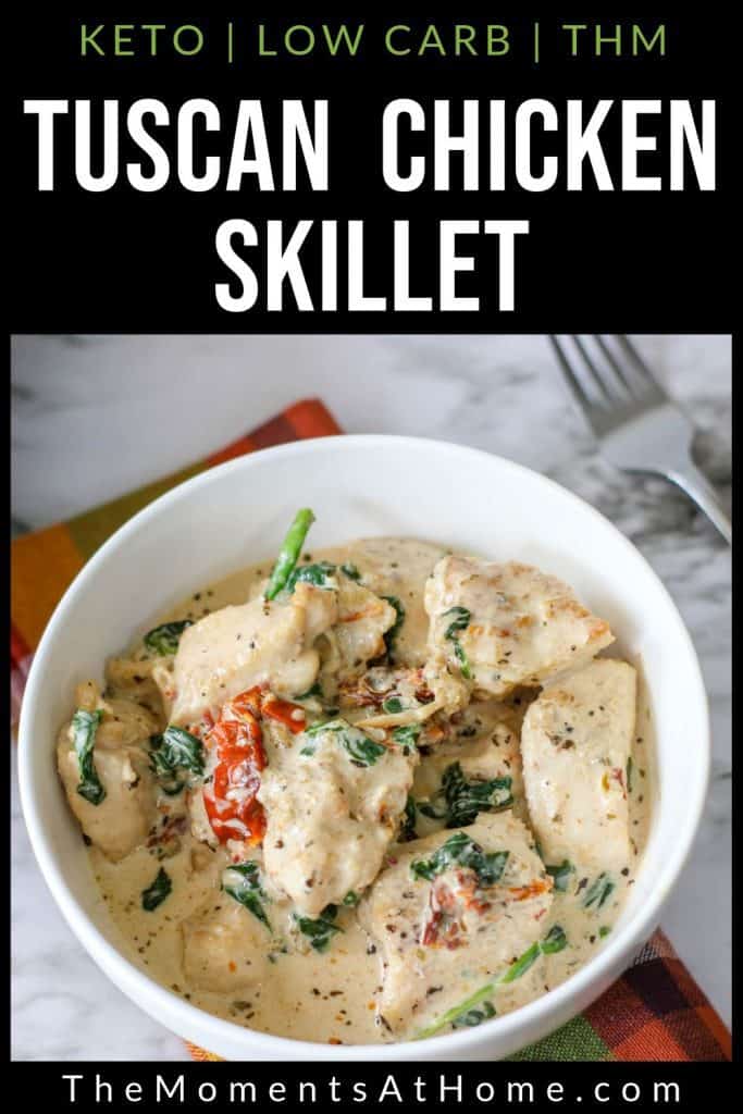 bowl of keto tuscan chicken with garlic cream sauce, tomato, basil or spinach, and bacon with text "tuscan chicken skillet: keto, low carb, THM" by The Moments At Home