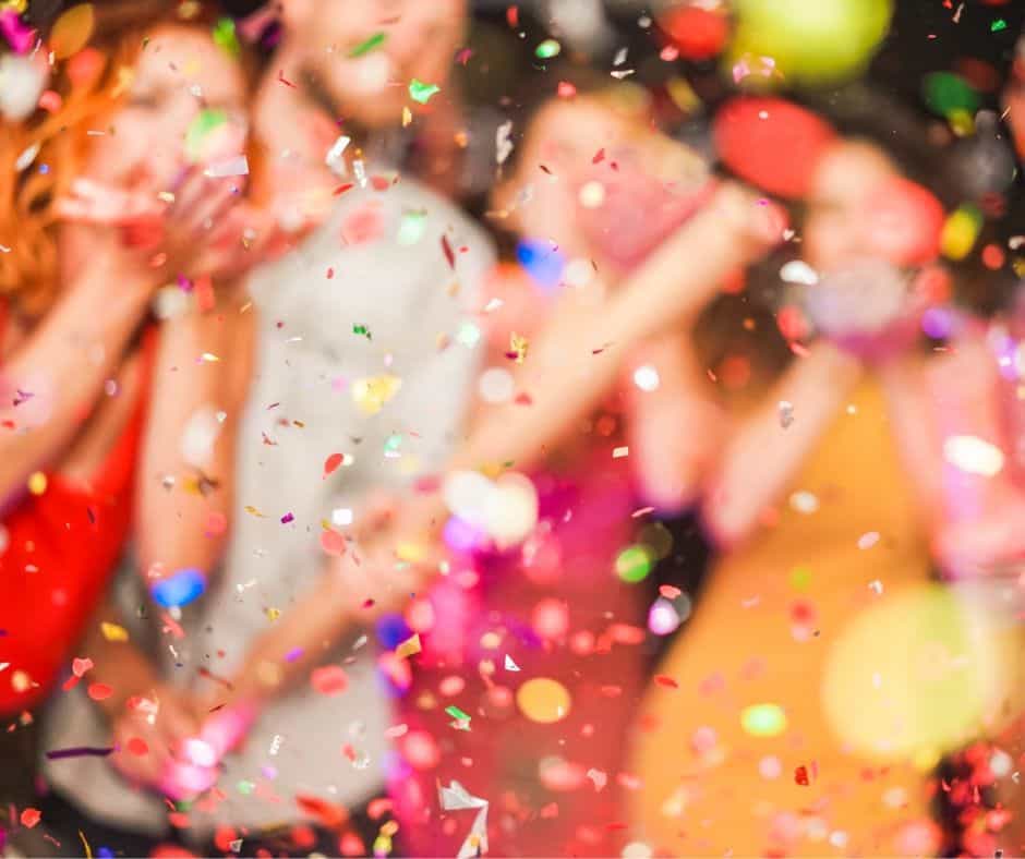 parents on New Years even with kids with streamers and confetti