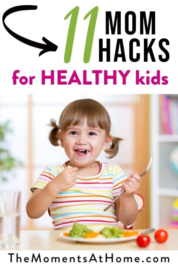 picture of toddler eating veggies with a smile and text "11 Mom Hacks for HEALTHY kids" by The Moments At Home