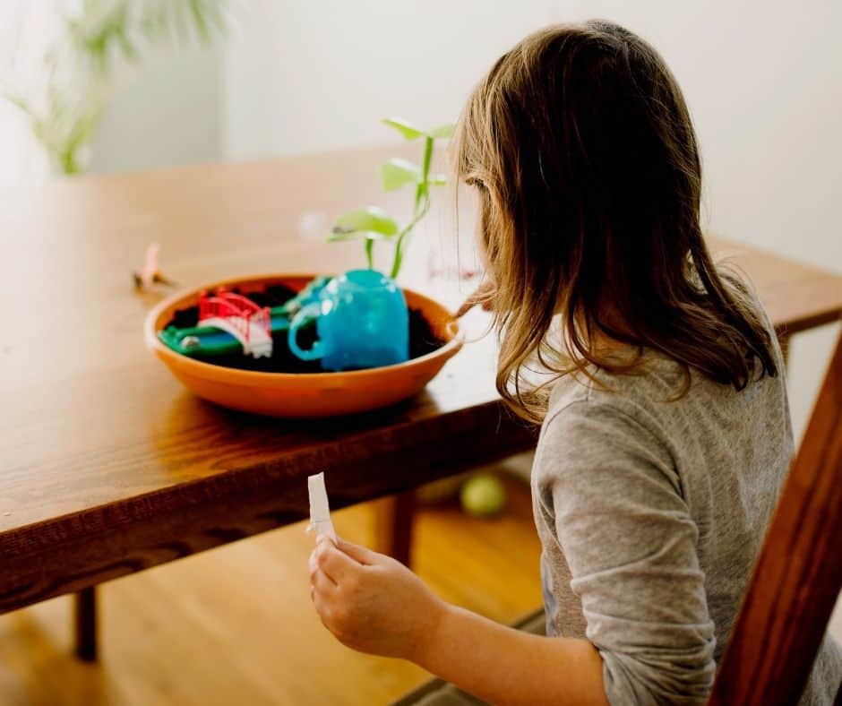 girl making a fairy garden at home