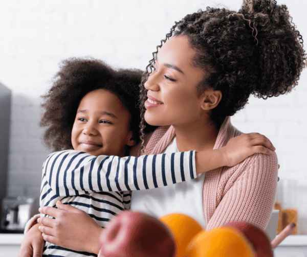 mom and daughter, hugging, smiling, looking together in the same direction